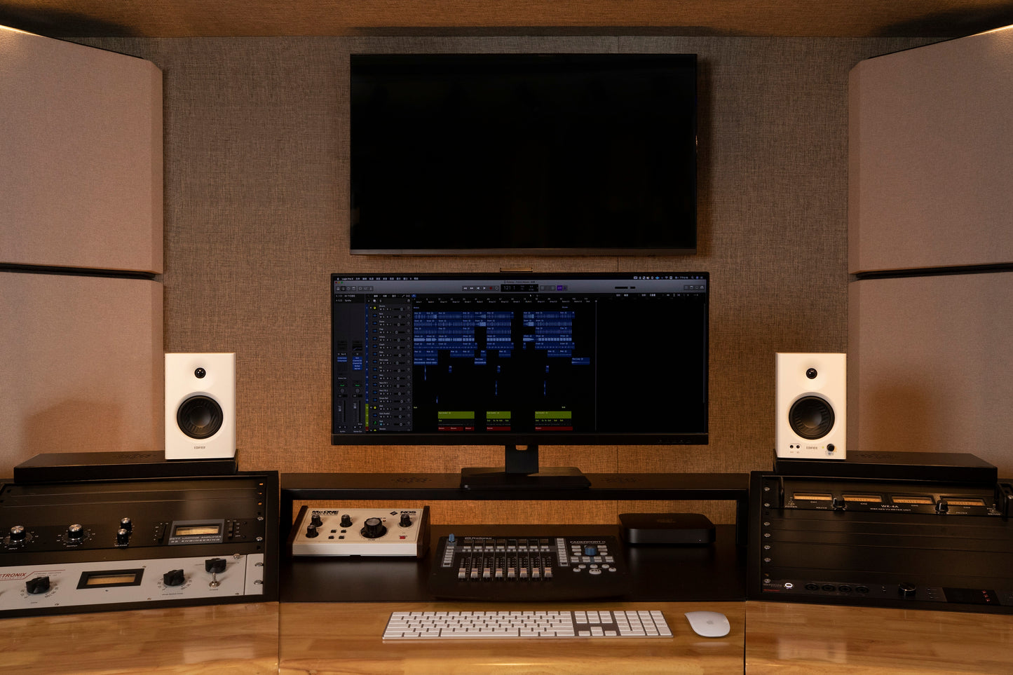 Monitores de estudio Edifier MR4 en color blanco en un estudio con pantalla de mezcla y tratamiento acústico.